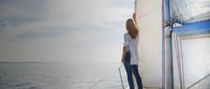 Woman on a sailboat, call a top rated Elmhurst family law attorney for help with your child support case.