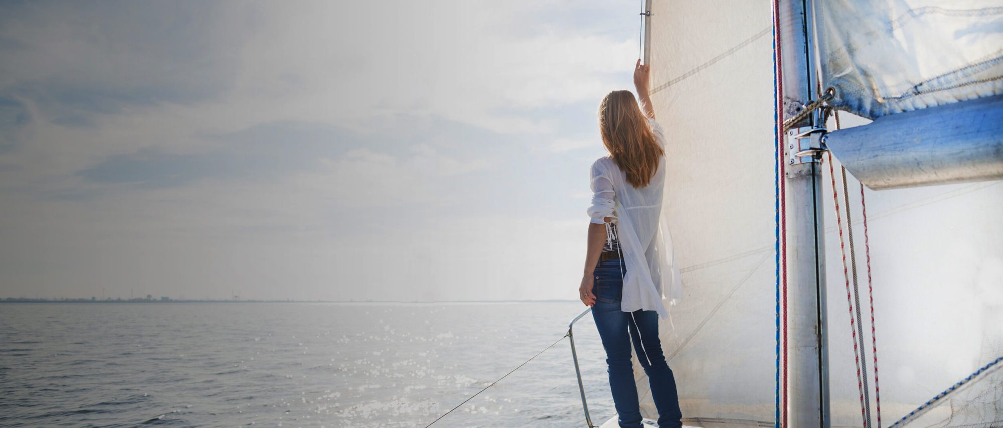 Woman on a sailboat, call a top rated Elmhurst family law attorney for help with your child support case.
