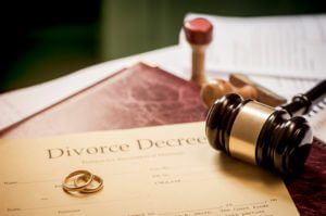 A divorce decree with rings and gavel, contact the Elmhurst family law lawyers for help with your child support case.