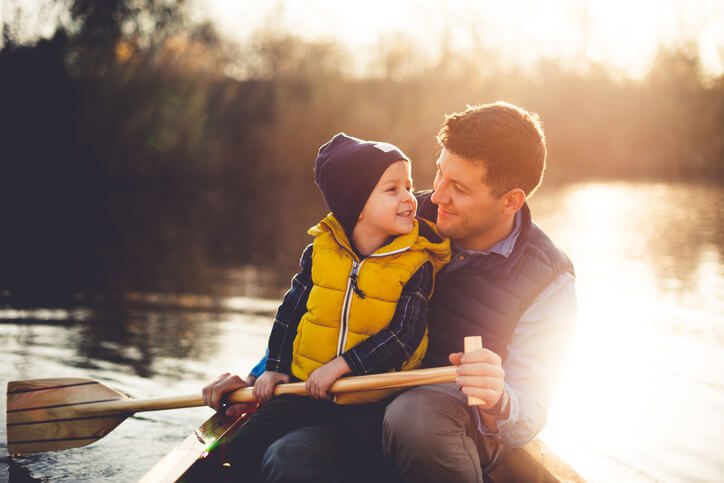 Father and son in a canoe on river, contact the St. Charles child custody lawyers for help with your parenting time case.