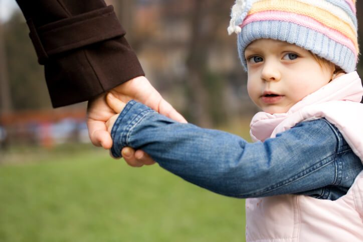 Little girl holding parent's hand, contact the Hinsdale child custody lawyers for help with your parenting time case.