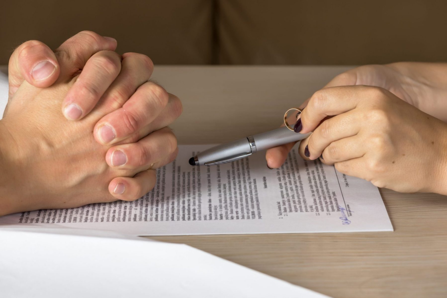 A couple signs a legal document after discussing spousal maintenance with a divorce attorney in Hinsdale.