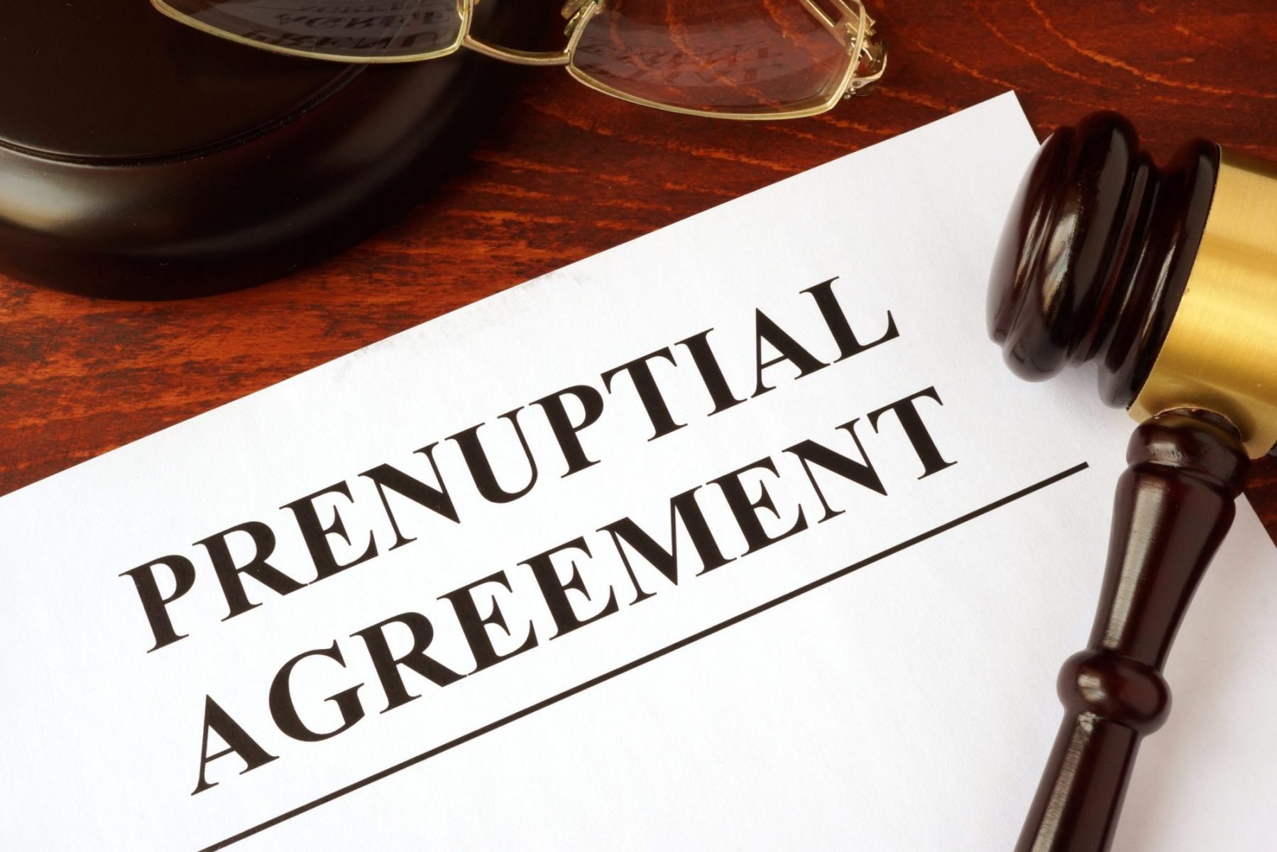 A prenuptial agreement and a gavel on the desk of a Naperville family law attorney.