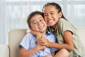 Brother and sister smiling and hugging, if you starting the divorce process meet with the best Mt. Prospect divorce attorney.