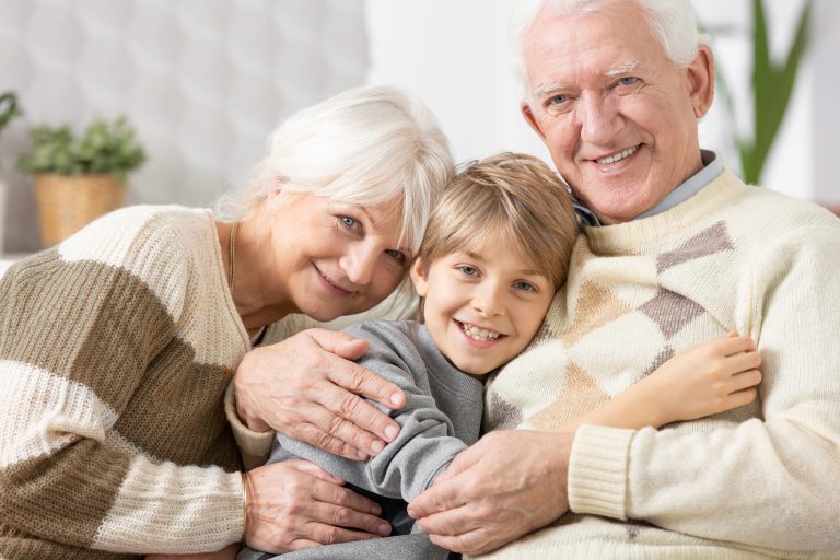 A young boy hugging his grandma and grandpa representing how you should call a Lombard family law lawyer.