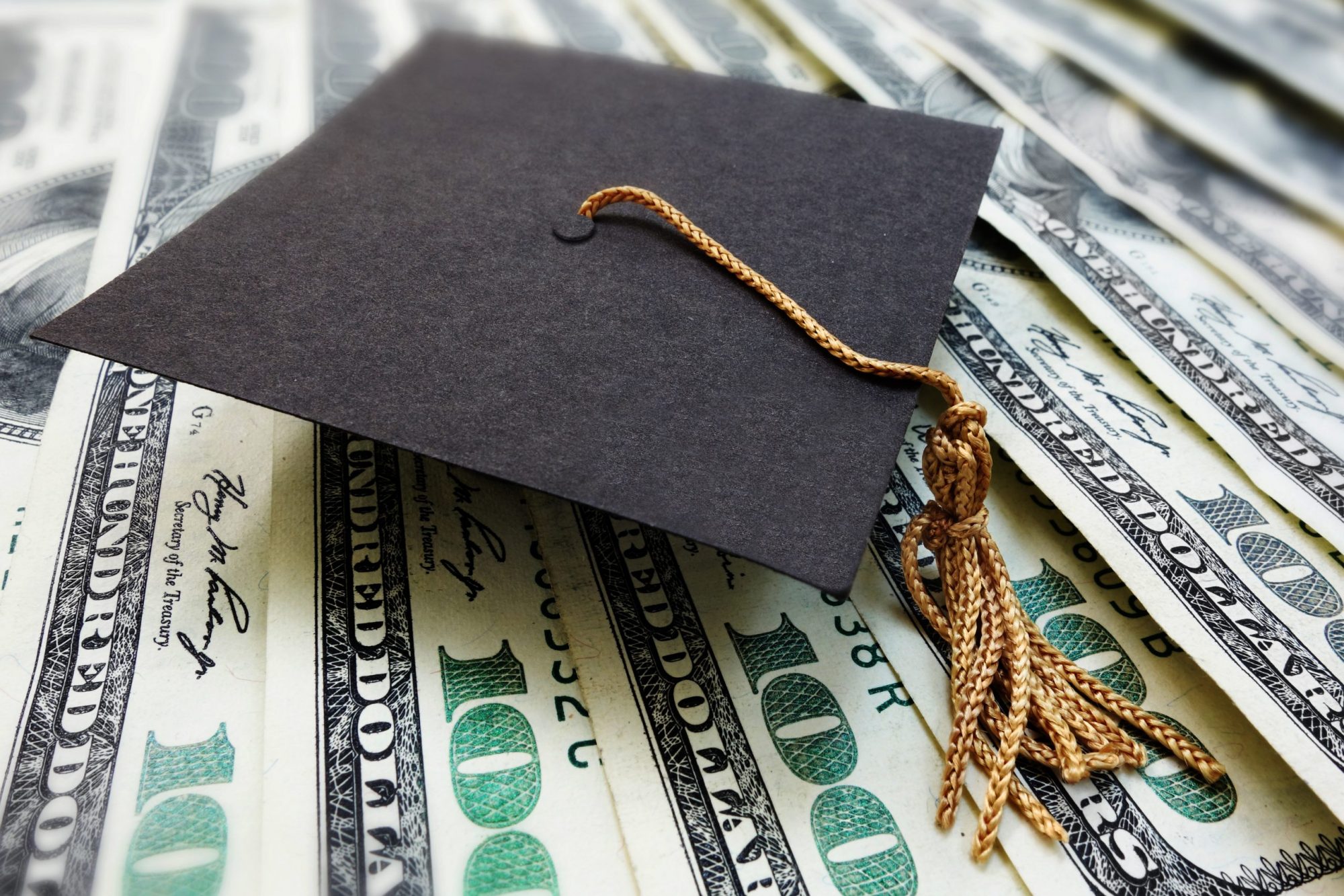 Mini Graduation cap on money, Meet with our illinois divorce attorney to discuss your options
