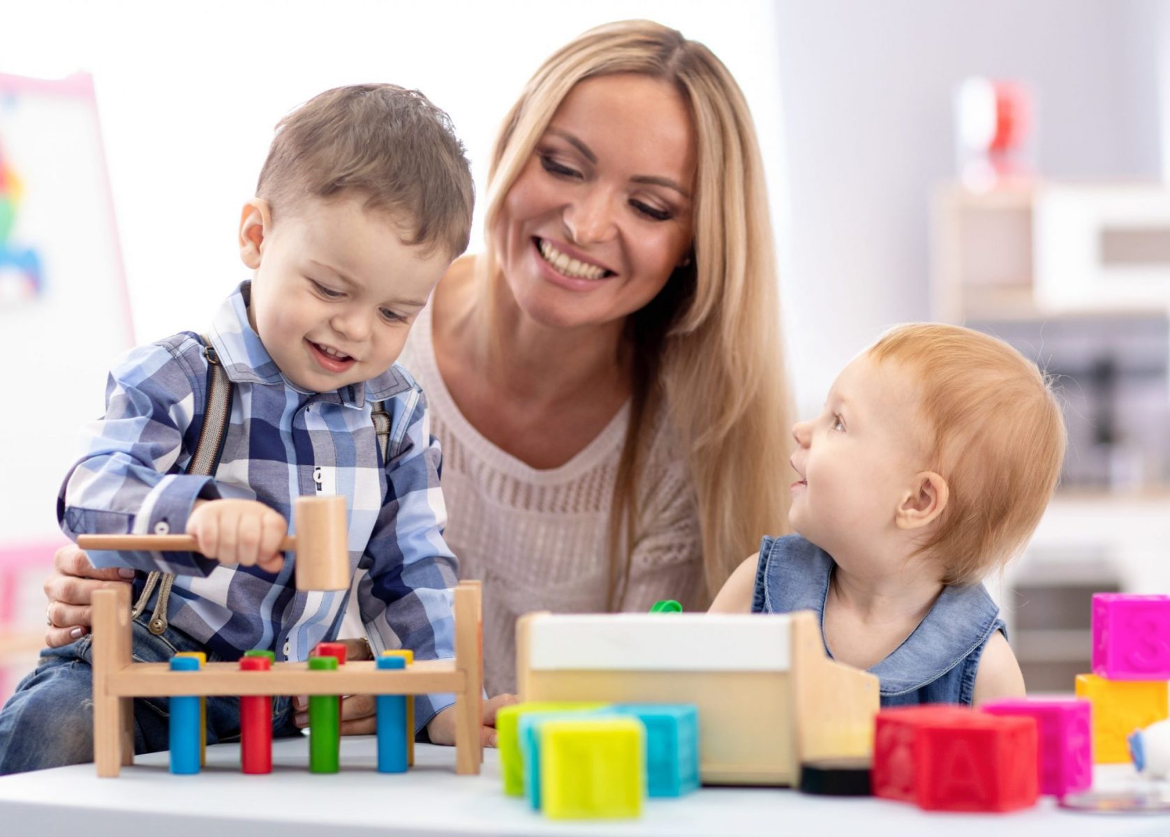 A mother and children playing with toys, when struggling with a relocation meet with a good family law attorney Oak Brook to discuss changes in parenting plan.