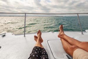 A couple relaxing on a boat in lake, when determining changes in alimony meet with High Asset Divorce Attorney Oak Brook.