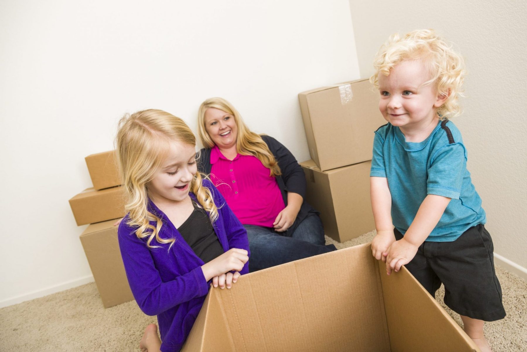 A mother with son and daughter playing with moving boxes, turn to Family Law Firm Chicago for help with custody modification.
