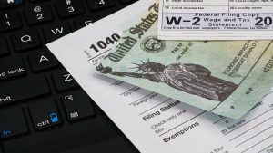 Tax form, refund check and w2 document, when determining marital assets with Divorce Lawyer in Downers Grove.
